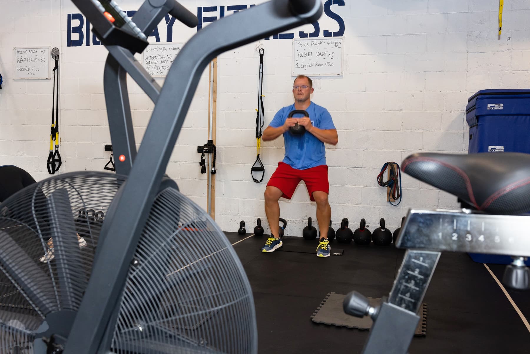 Member performing a kettlebell goblet squat with proper form at Big Day Fitness