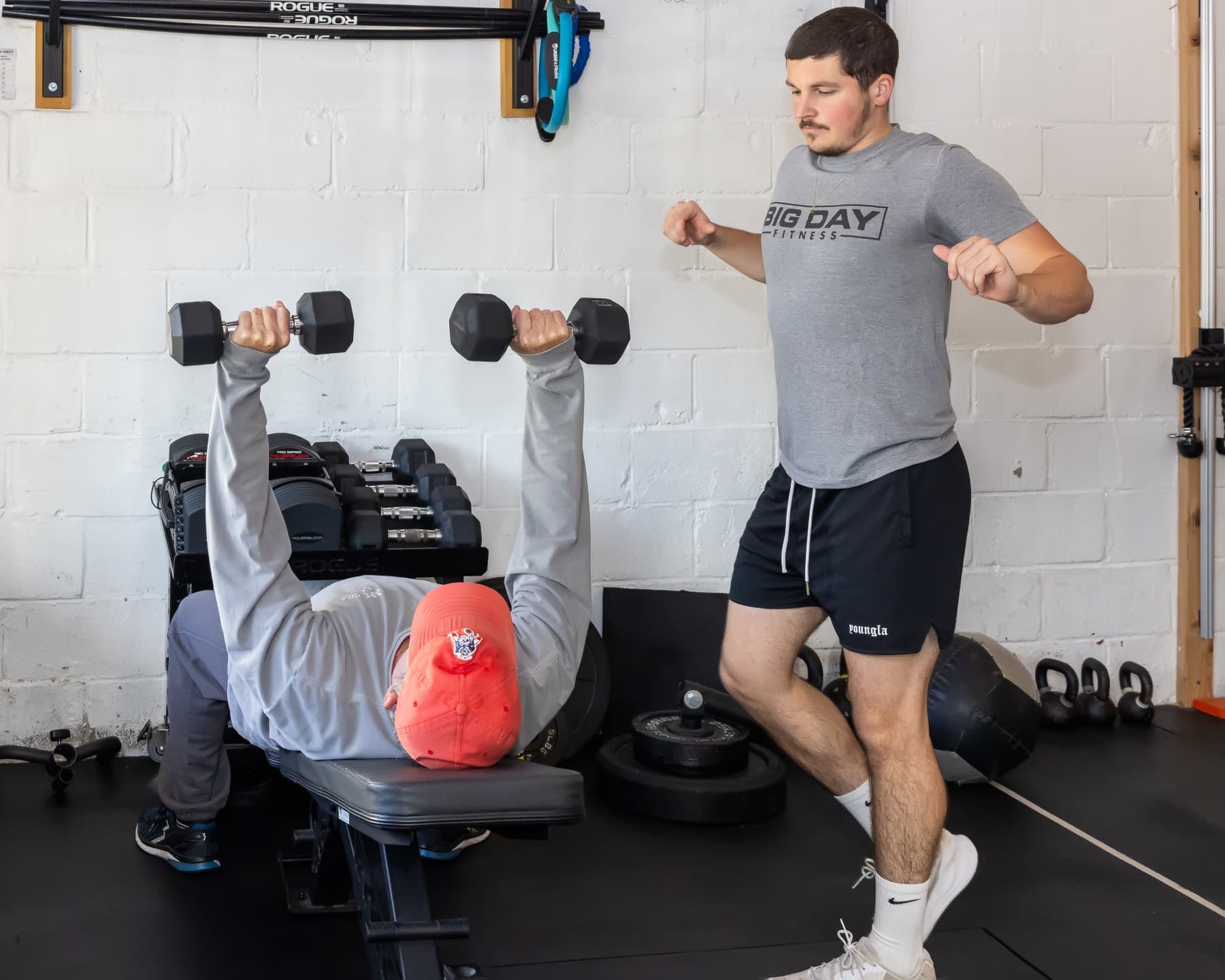 Coach guiding a member through strength training at Big Day Fitness